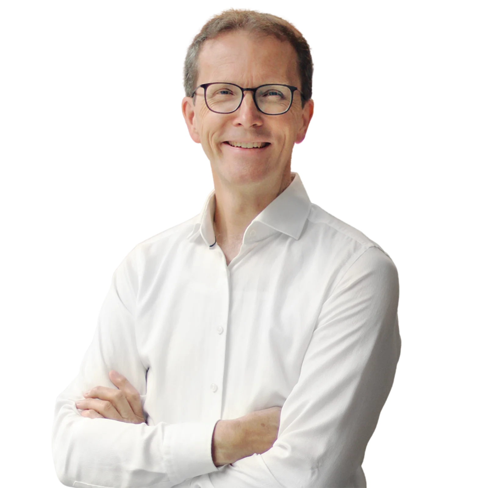 Portrait of Jürgen Görner wearing glasses and a white shirt, smiling with arms crossed.