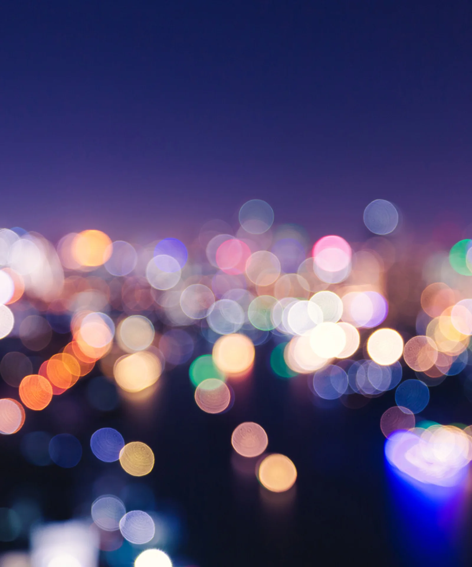 A vibrant, blurred cityscape at night, symbolising the dynamic and personalised nature of modern insurance solutions.