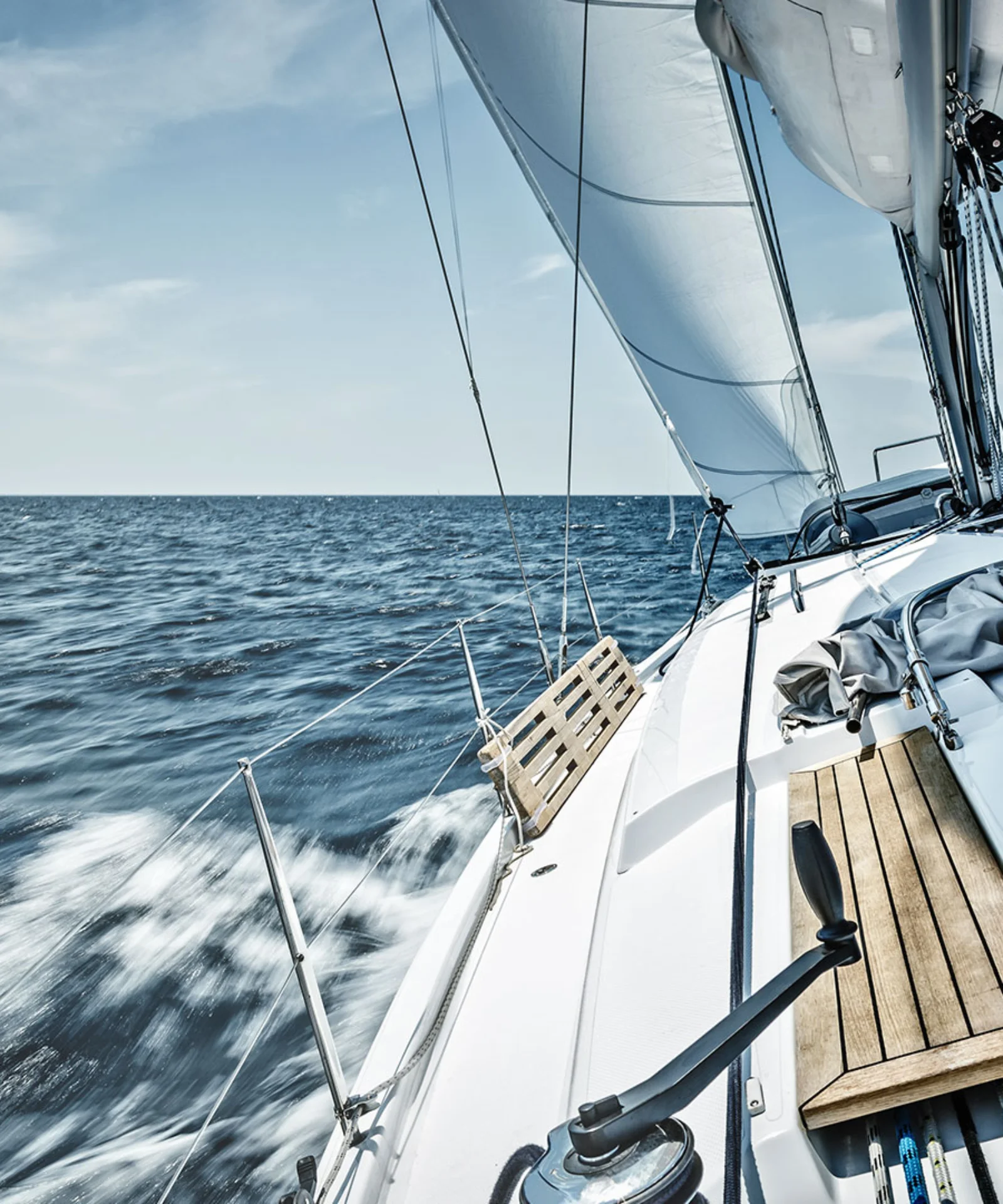 A sailboat cruising through the open sea under a clear blue sky, representing the BankLiteX solution. The image showcases the sleek design and advanced technology of the sailboat, symbolizing innovation, freedom, and efficiency.