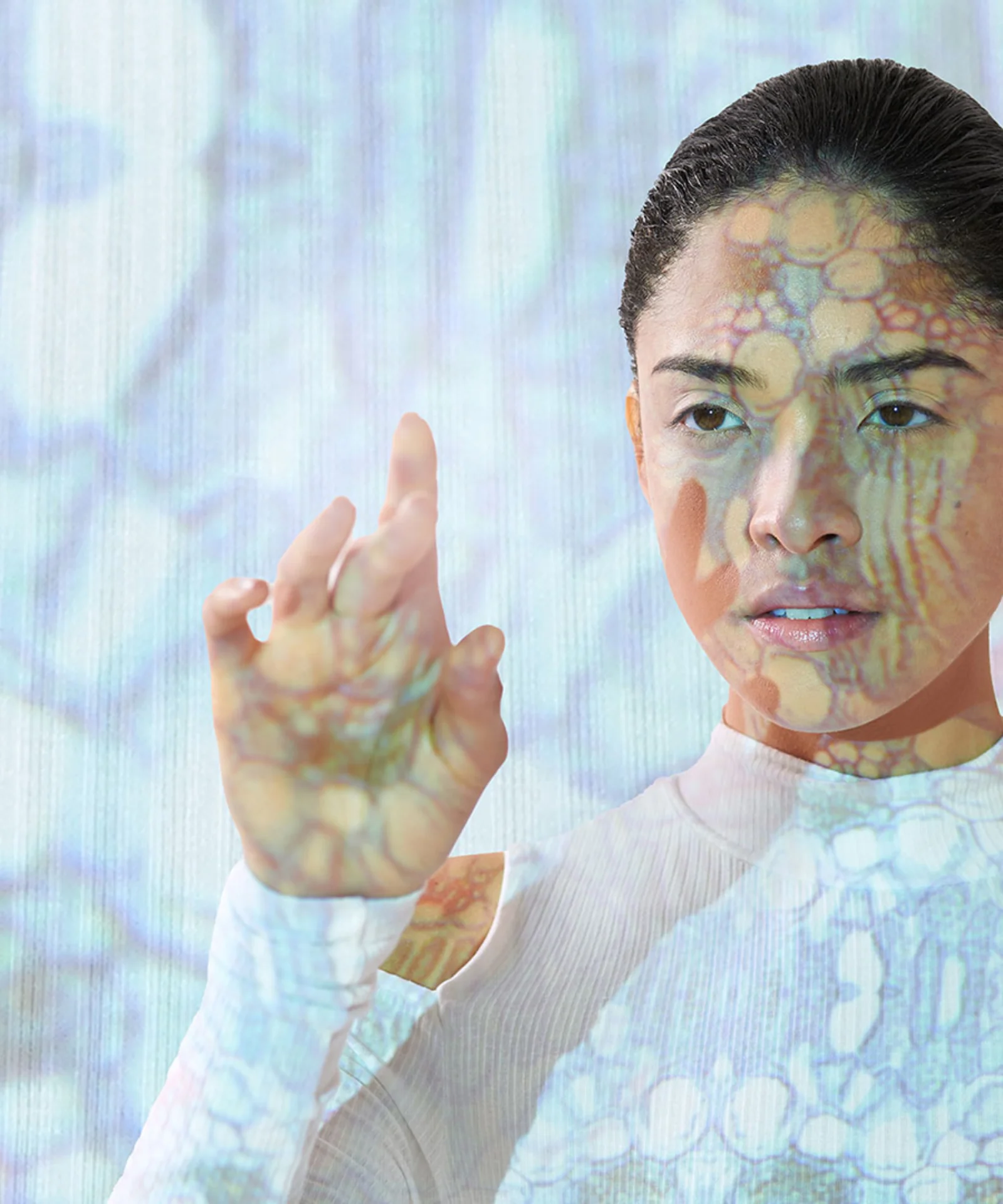 A person interacts with a digital interface, overlaid with intricate patterns, symbolising the diverse use cases of artificial intelligence in modern technology.