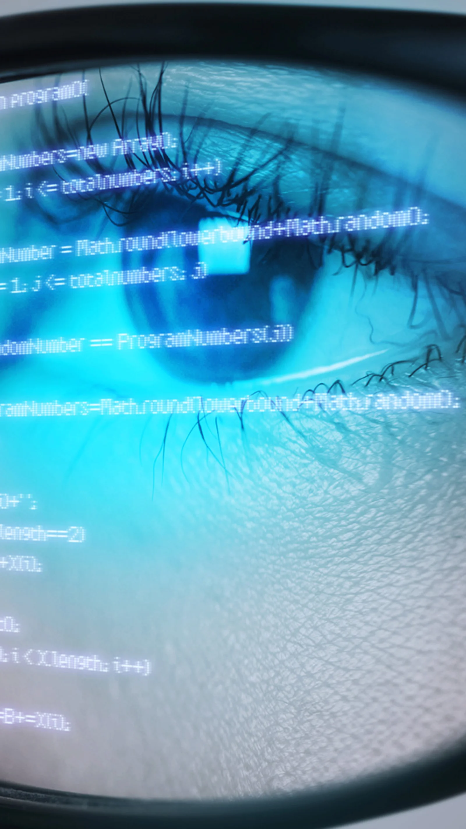 Close-up of a person&#039;s eye reflecting code on a screen, symbolizing in-depth analysis and focus in software development.