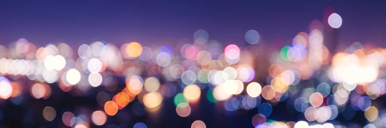 A vibrant, blurred cityscape at night, symbolising the dynamic and personalised nature of modern insurance solutions.