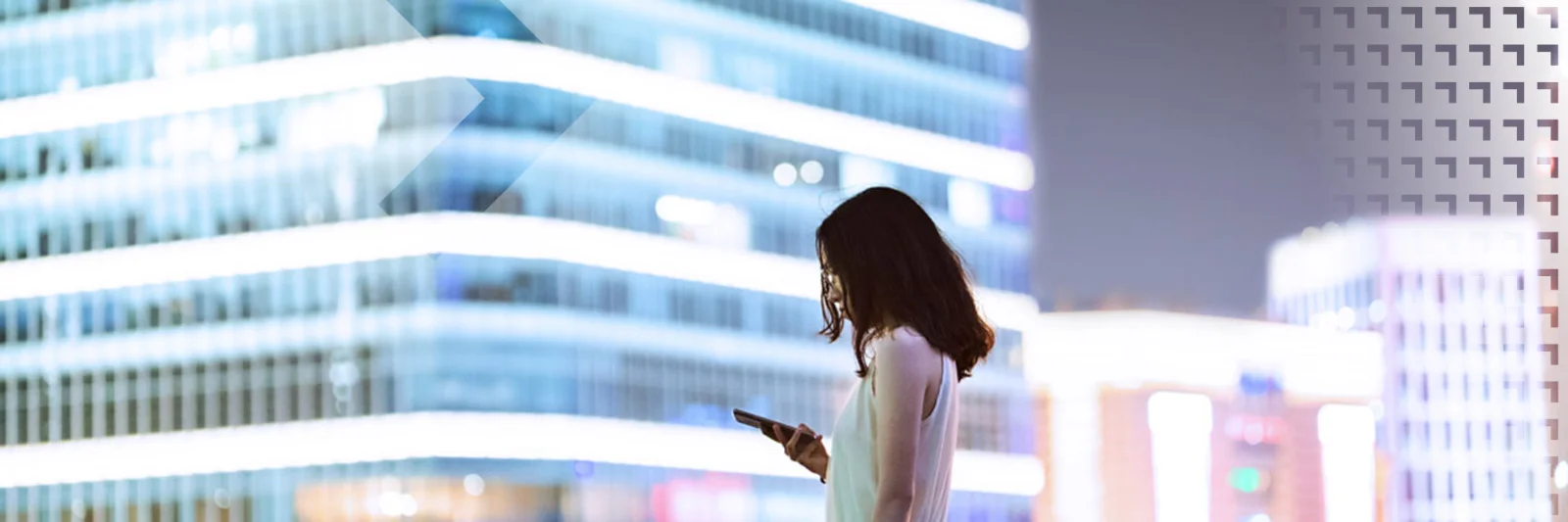 A professional woman using her smartphone with a modern cityscape in the background, symbolizing the impact of Central Bank Digital Currencies (CBDCs) on the future of commercial banking.