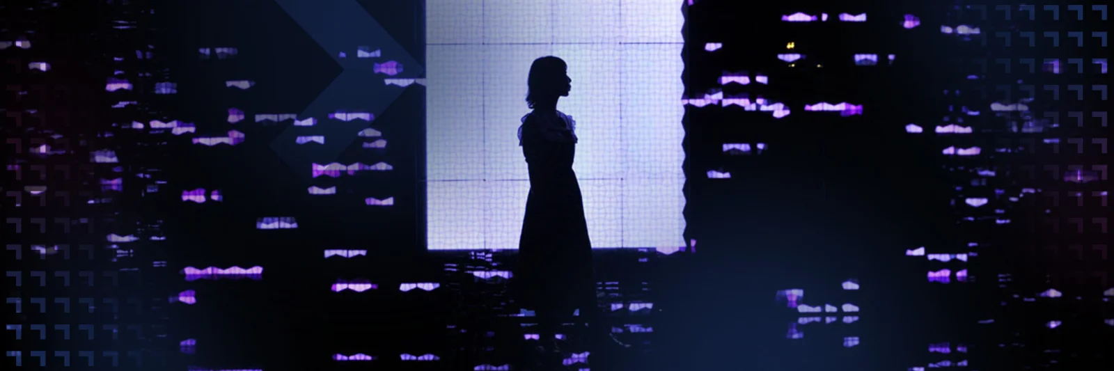 Silhouette of a person standing against a background of digital lights and screens, representing the intersection of technology and human presence in a digital world.