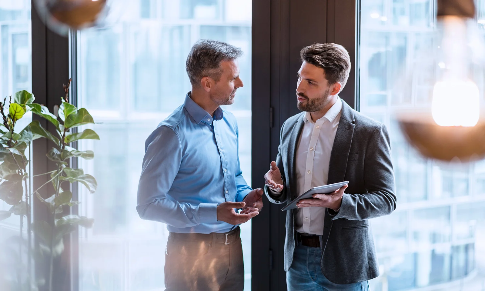 Two professionals engaged in a focused discussion, symbolizing collaboration and problem-solving in a modern office environment.