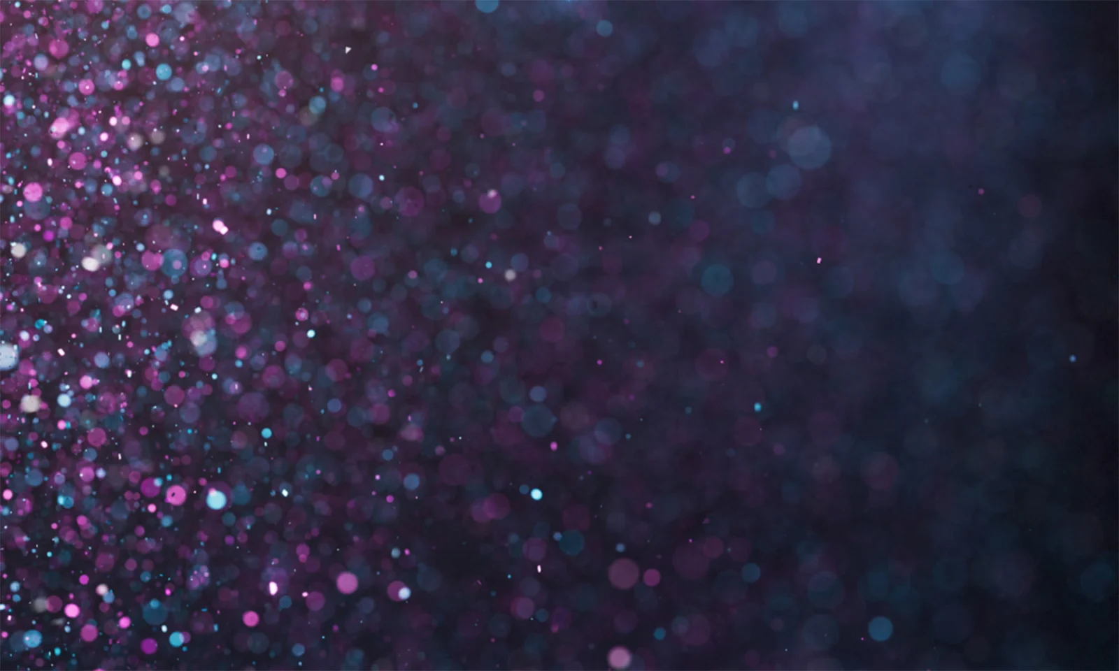 Abstract image with a right-aligned focus, featuring a glittering background of purple, blue, and white sparkles. The design symbolises the celebration of GFT&#039;s numerous awards and achievements.