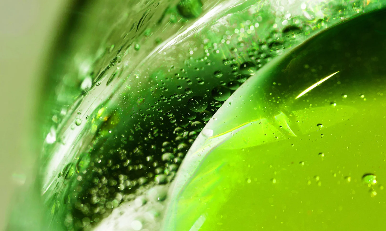 Macro shot of vibrant green liquid with bubbles, symbolizing sustainability and eco-friendly investments.