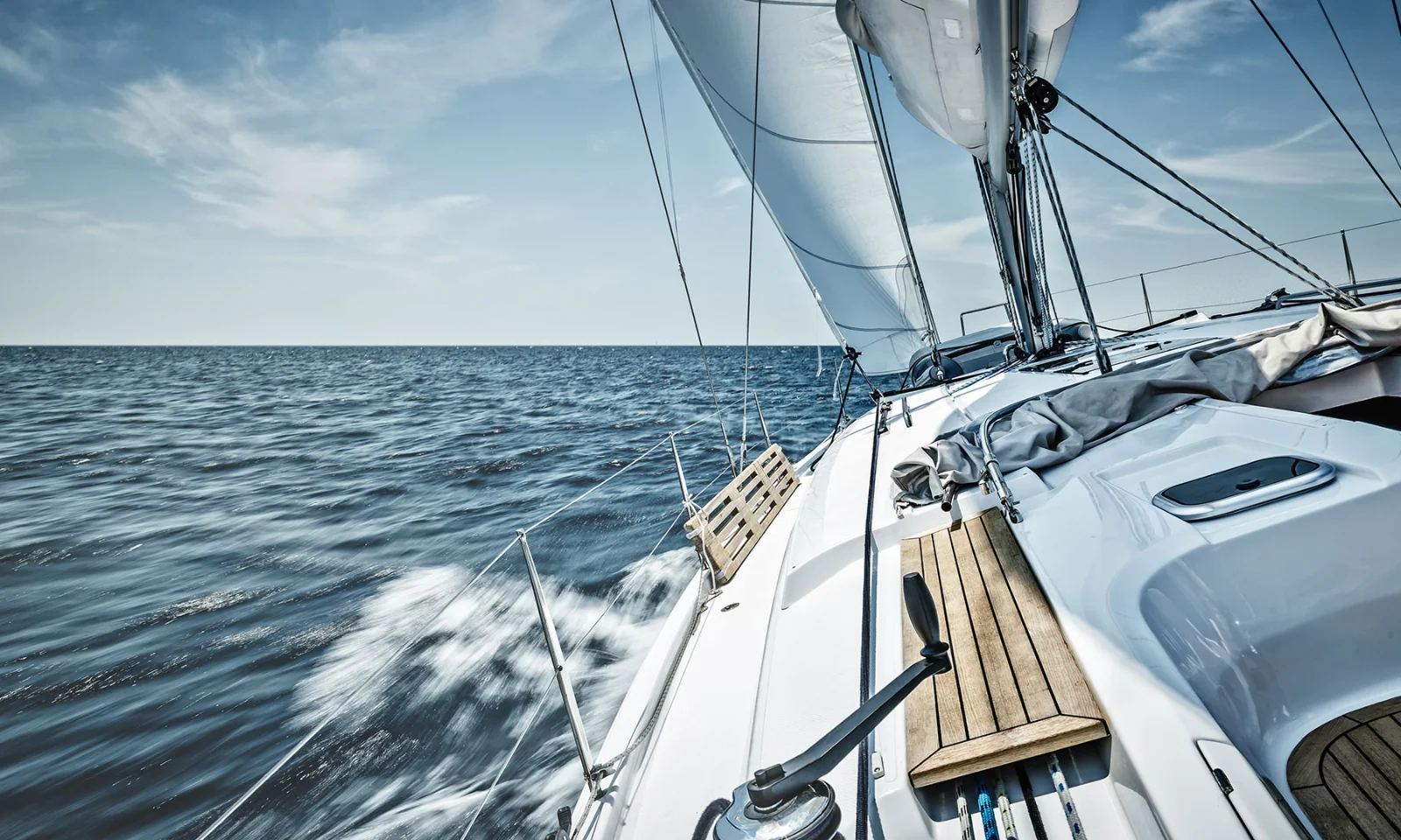 A sailboat cruising through the open sea under a clear blue sky, representing the BankLiteX solution. The image showcases the sleek design and advanced technology of the sailboat, symbolizing innovation, freedom, and efficiency.