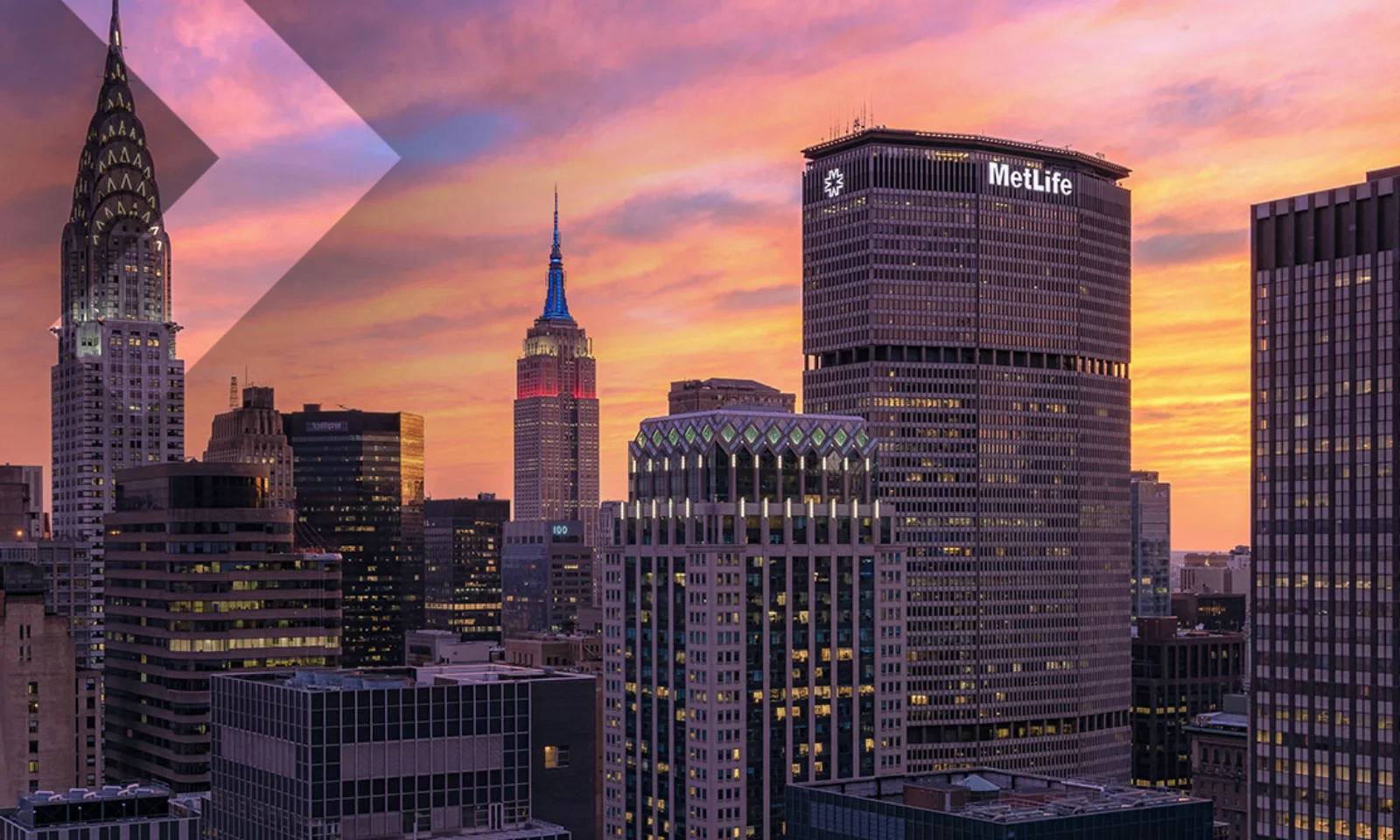 New York City skyline at sunset, highlighting the Chrysler Building and MetLife Building with a vibrant sky.