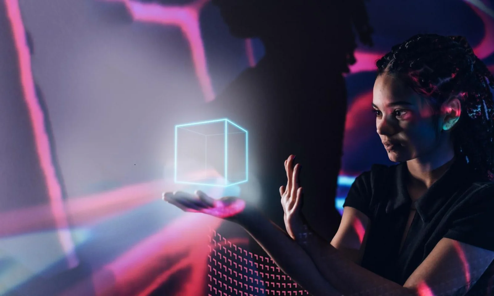 A woman interacting with a holographic cube, symbolising advanced artificial intelligence and data visualisation, with a futuristic digital background.