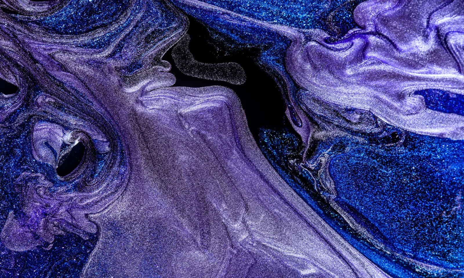 An abstract visual featuring swirling patterns of blue and purple colors, representing creativity and innovation in design services.