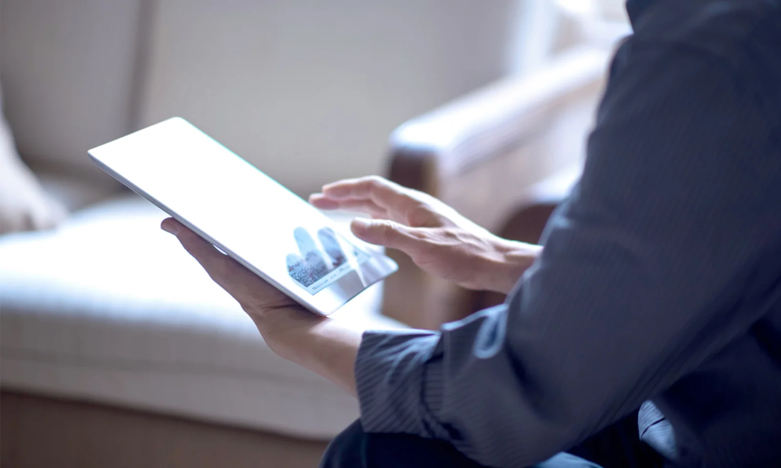 Key visual image representing financial news and reports, featuring a person interacting with a digital tablet, symbolizing the modern access to financial information and updates.